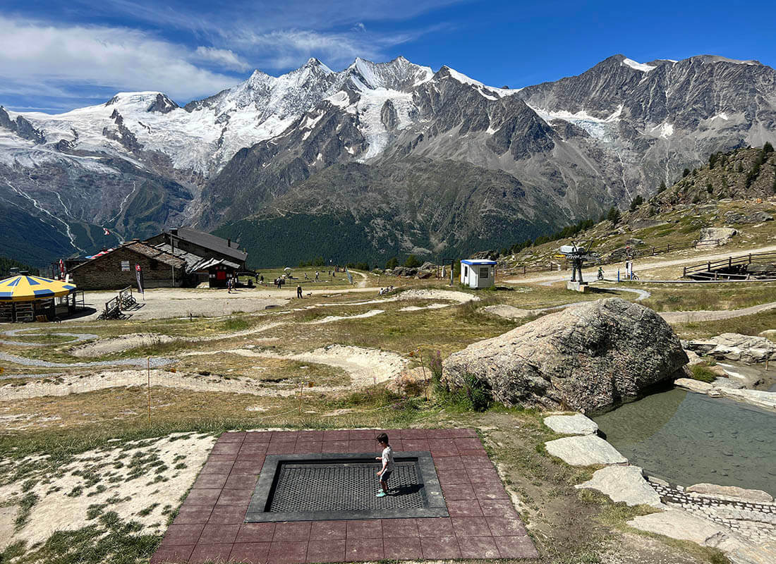 NIño saltando en una cama elástica en el parque de Kreuzboden en Suiza